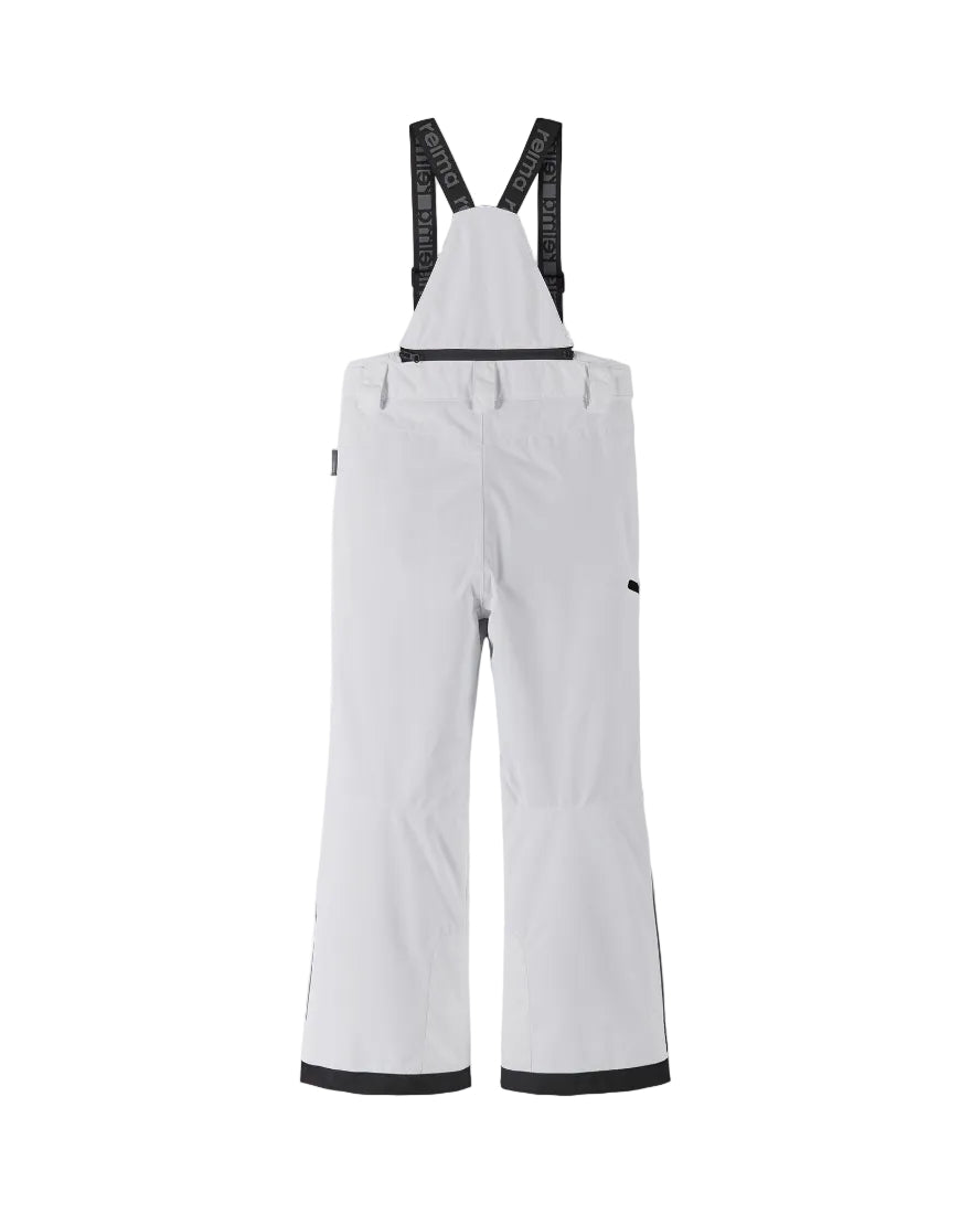 Rear view of white Reima Jr Terrie Pants featuring a waterproof Reimatec shell, detachable elastic suspenders, reinforced ankle scuff guards, and internal snow gaiters.