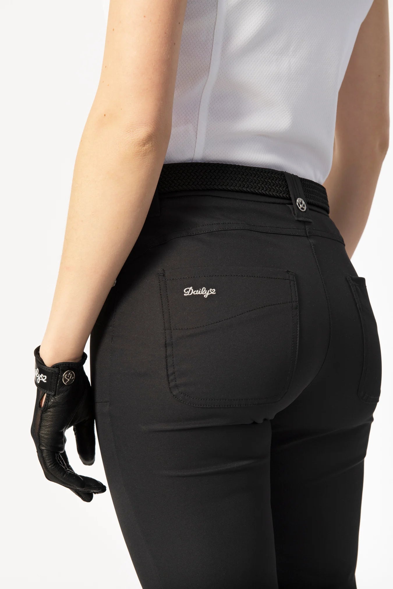 A woman wearing a pair of black Daily Sports Women’s Lyric High Water Golf Pants on a white background