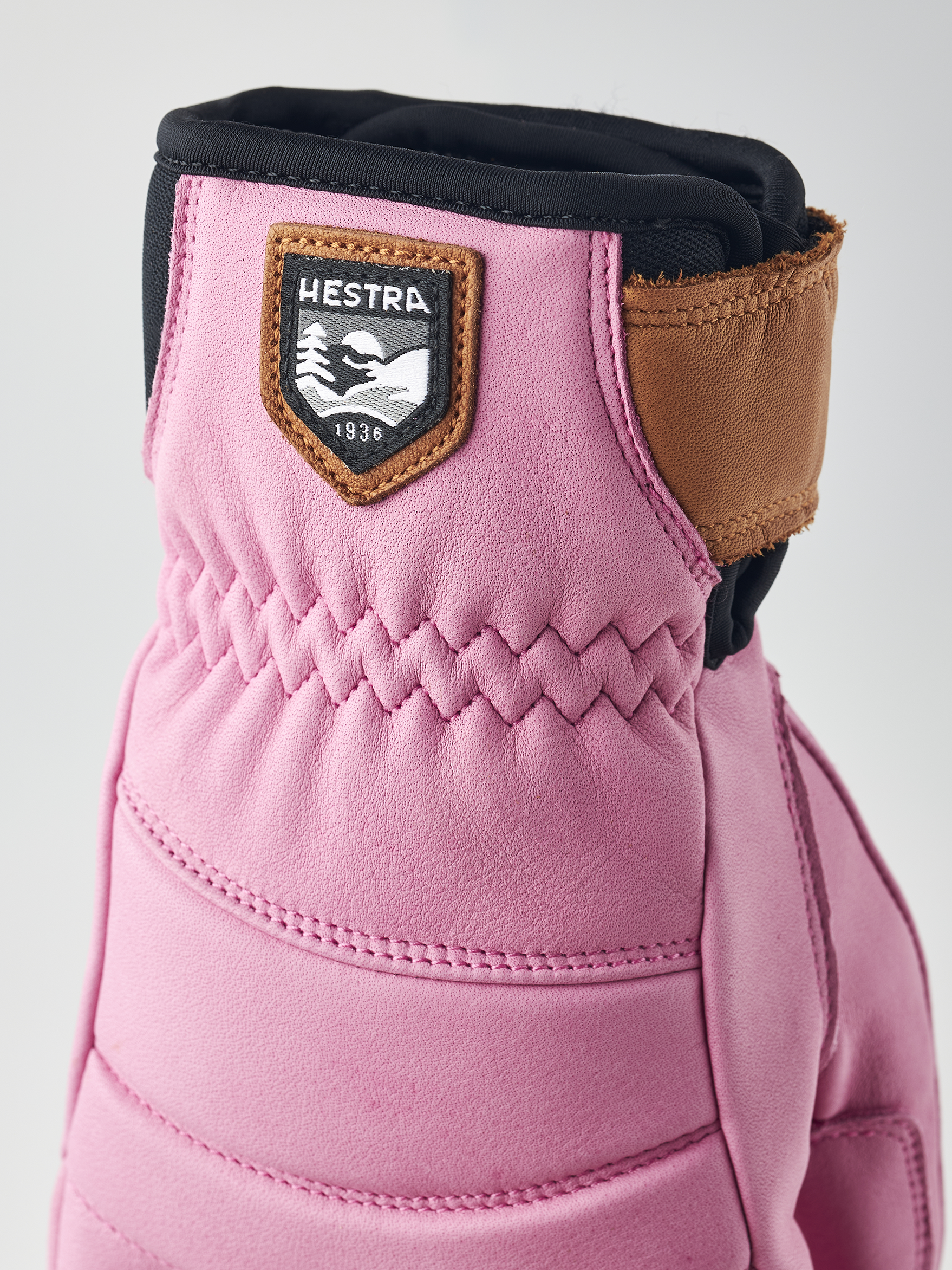 A pink Hestra Women's Fall Line Glove that is made from premium leather.