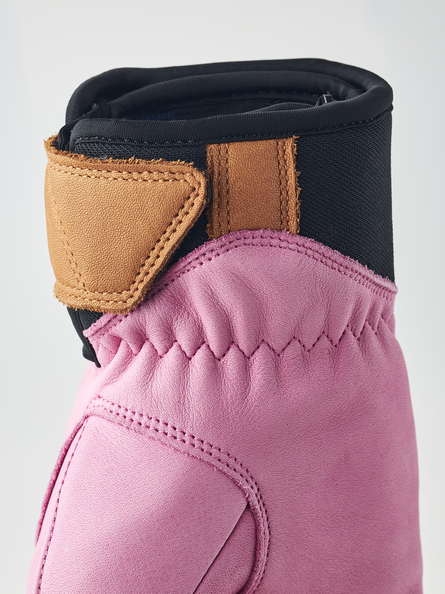 A pink Hestra Women's Fall Line Glove that is made from premium leather.