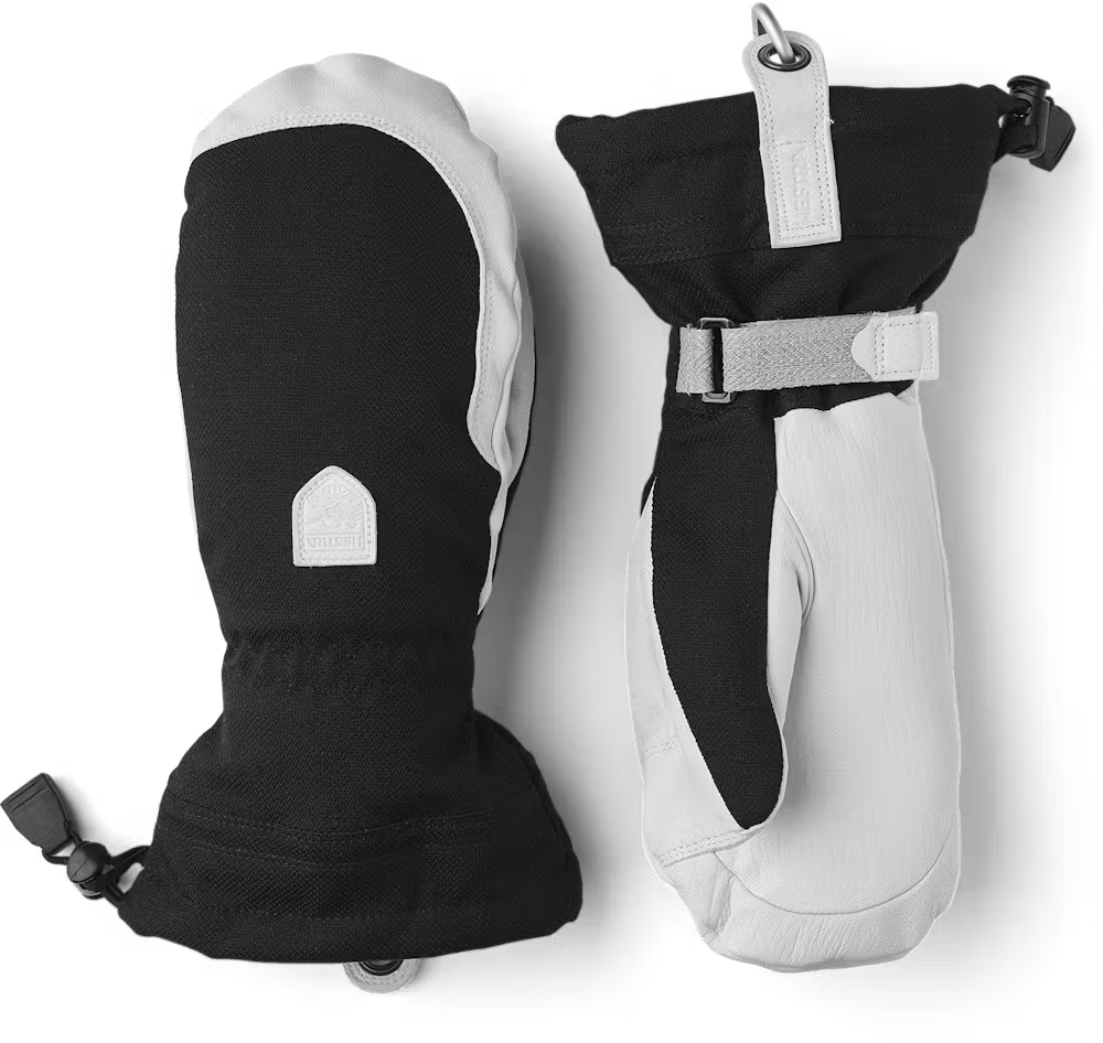 A pair of black and white Hestra Women’s Patrol Gauntlet Mittens, which are designed to keep your hands war and dry in harsh winter conditions.