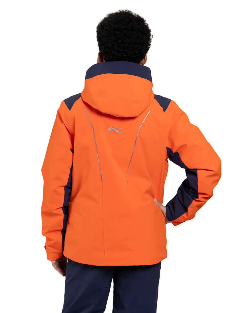 Rear view of an orange Kjus Jr Boys’ Formula Jacket featuring 4-way stretch waterproof fabric, Fast Thermo Core insulation, water-repellent zippers, and the KJUS-GROW sleeve extension system.