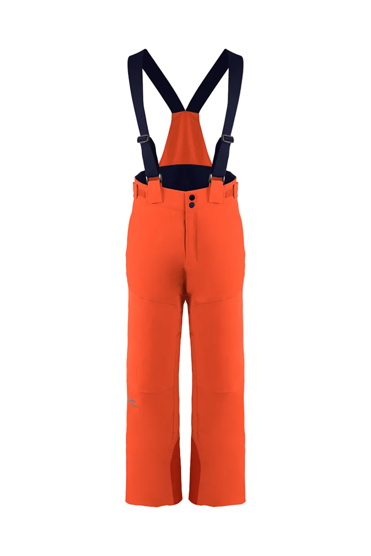 Front view of orange Kjus Jr Boys’ Vector Max Pants featuring 2-layer waterproof fabric, Fast Thermo Core insulation, water-repellent zippers, reinforced scuff guards, and the KJUS-GROW leg extension system.