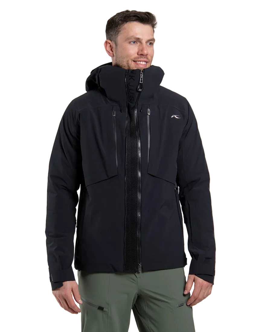 Front view of a black Kjus Men’s Frx Lucas Shell Jacket featuring 3-layer waterproof membrane fabric, water-repellent zippers, AC-Vent ventilation ports, and an adjustable helmet-compatible hood.