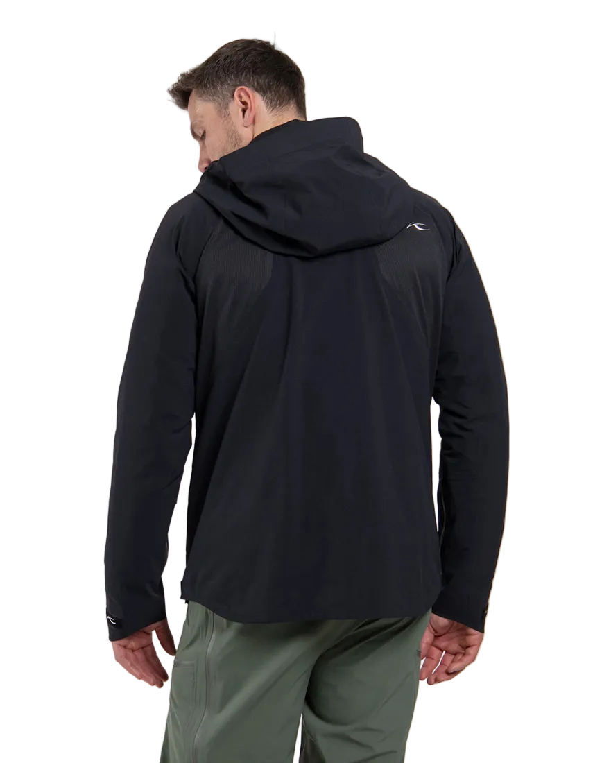 Rear view of a black Kjus Men’s Frx Lucas Shell Jacket featuring 3-layer waterproof membrane fabric, water-repellent zippers, AC-Vent ventilation ports, and an adjustable helmet-compatible hood.