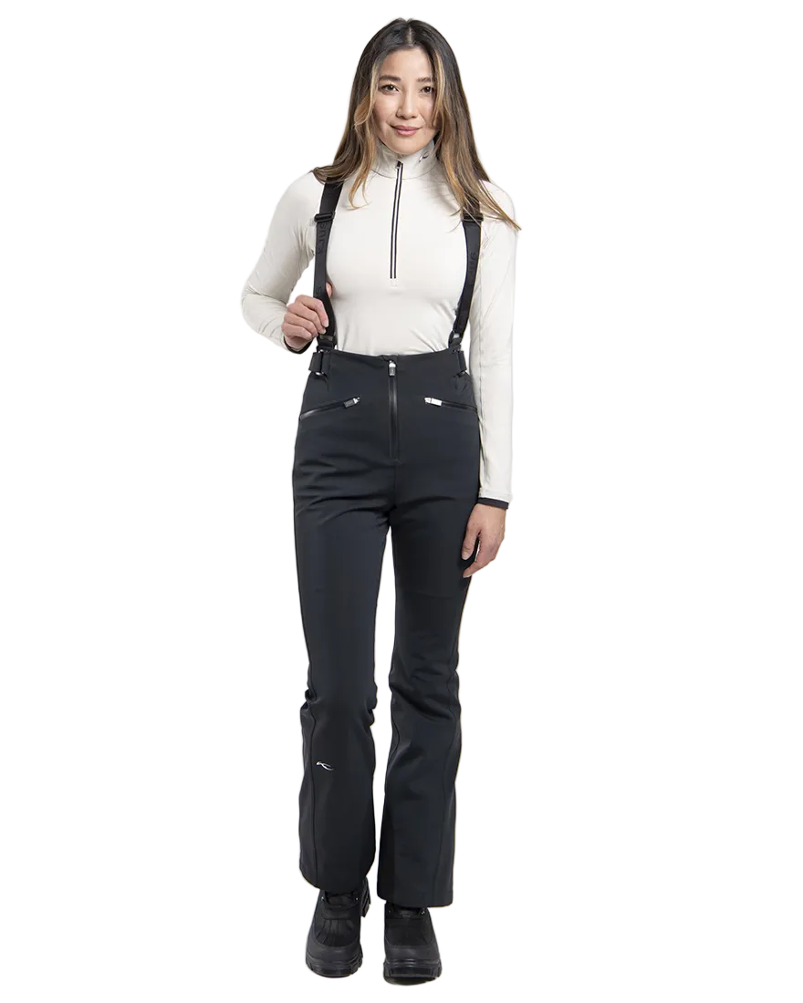 Front view of black Kjus Women’s Core Embrace Pants featuring 4-way stretch waterproof fabric, high-efficiency thermal insulation, water-repellent zippers, reinforced scuff guards, and internal snow gaiters.