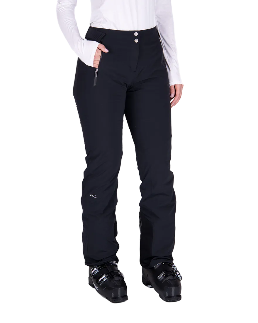 Front view of black Kjus Women’s Formula Pants featuring 4-way stretch waterproof fabric, Fast Thermo Core insulation, water-repellent zippers, and Schoeller Keprotec reinforced scuff guards.