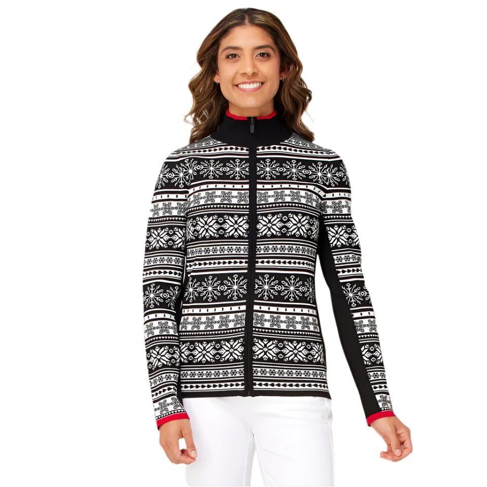A woman wearing a black and white Krimson Klover Women's Holiday Cardigan Snow that features 4-way stretch, a brethable knit, and a geometric snowflake pattern.