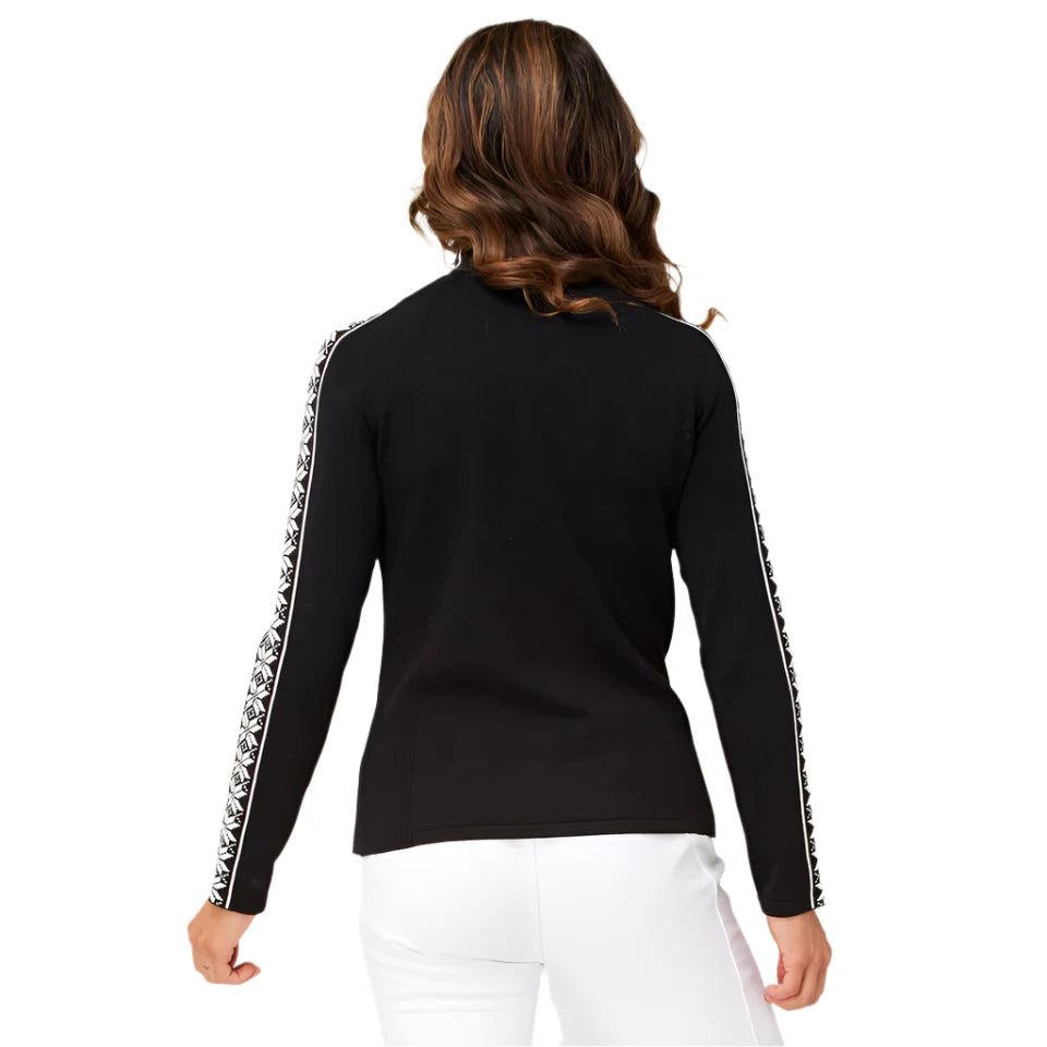 A woman wearing a black Krimson Klover Women's Slalom Zip Neck Sweater with white snowflake jacquard sleeve details and a quarter zip front.