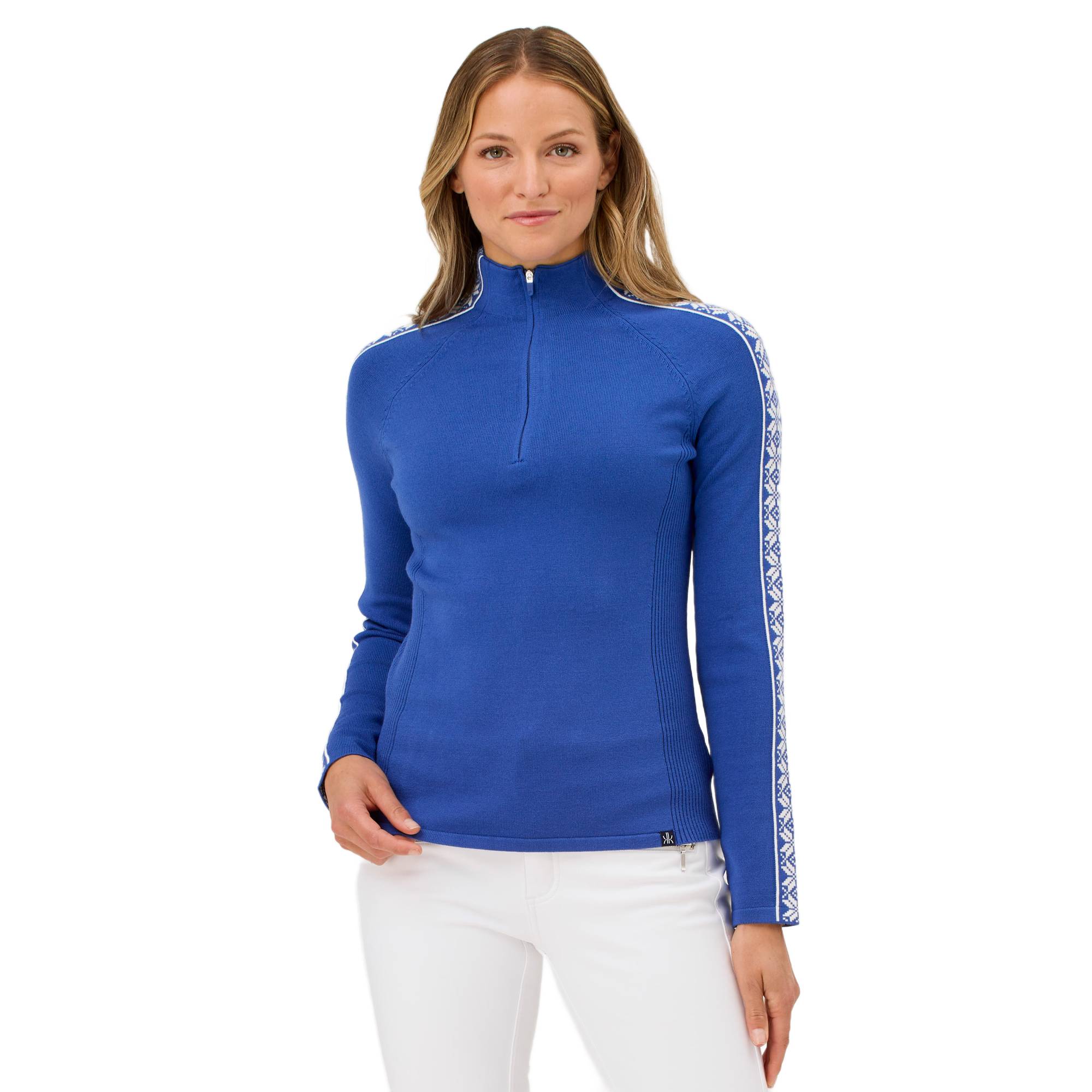 A woman wearing a blue Krimson Klover Women's Slalom Zip Neck Sweater with white snowflake jacquard sleeve details and a quarter zip front.