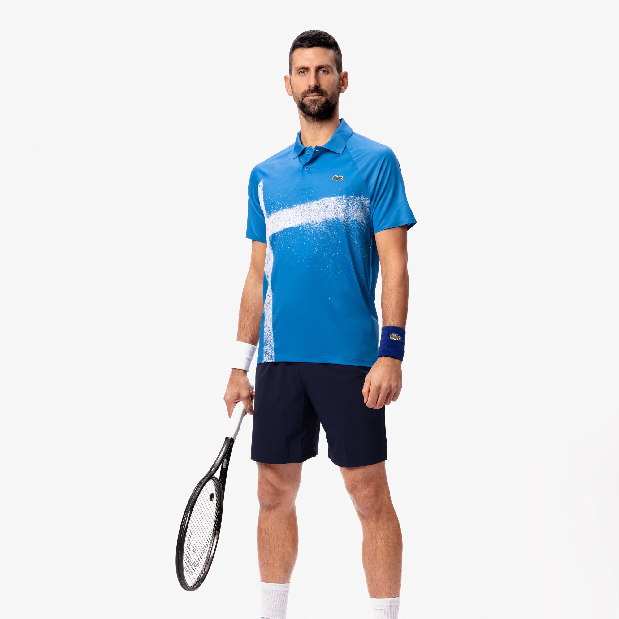Lacoste Men's Tennis x Novak Djokovic On-Court Polo featuring breathable performance fabric, athletic fit, and signature collection detailing.