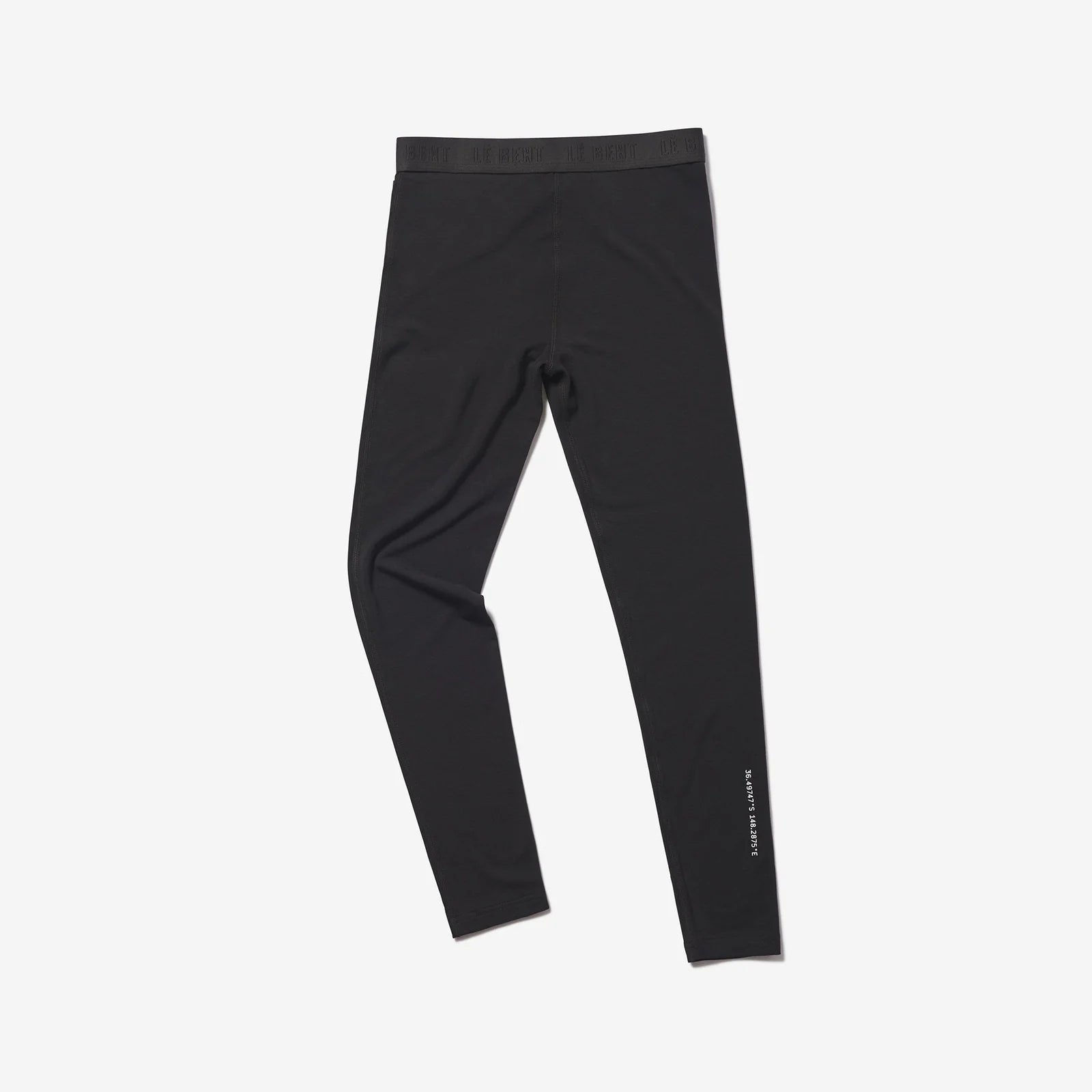 A pair of black Le Bent Kids' Core Midweight Baselayer Bottoms that are stretchable, breathable, and made from a premium bamboo and merino wool blend.