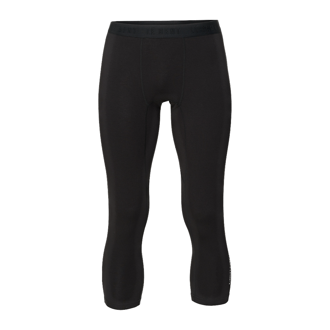 A pair of black Le Bent Men's Core Lightweight 3/4 Length Baselayer Bottoms that are made from a bamboo and merino wool blend.