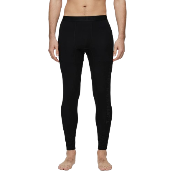 A man wearing a pair of Le Bent Men's Core Midweight Baselayer Bottoms that are made with a bamboo and merino wool blend.