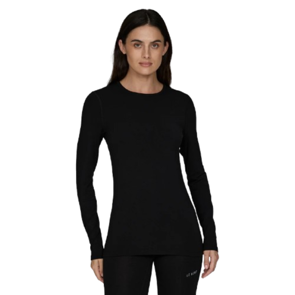 A woman wearing a black Le Bent Women's Core Midweight Crewneck Baselayer Top that is made from a bamboo and merino wool blend.