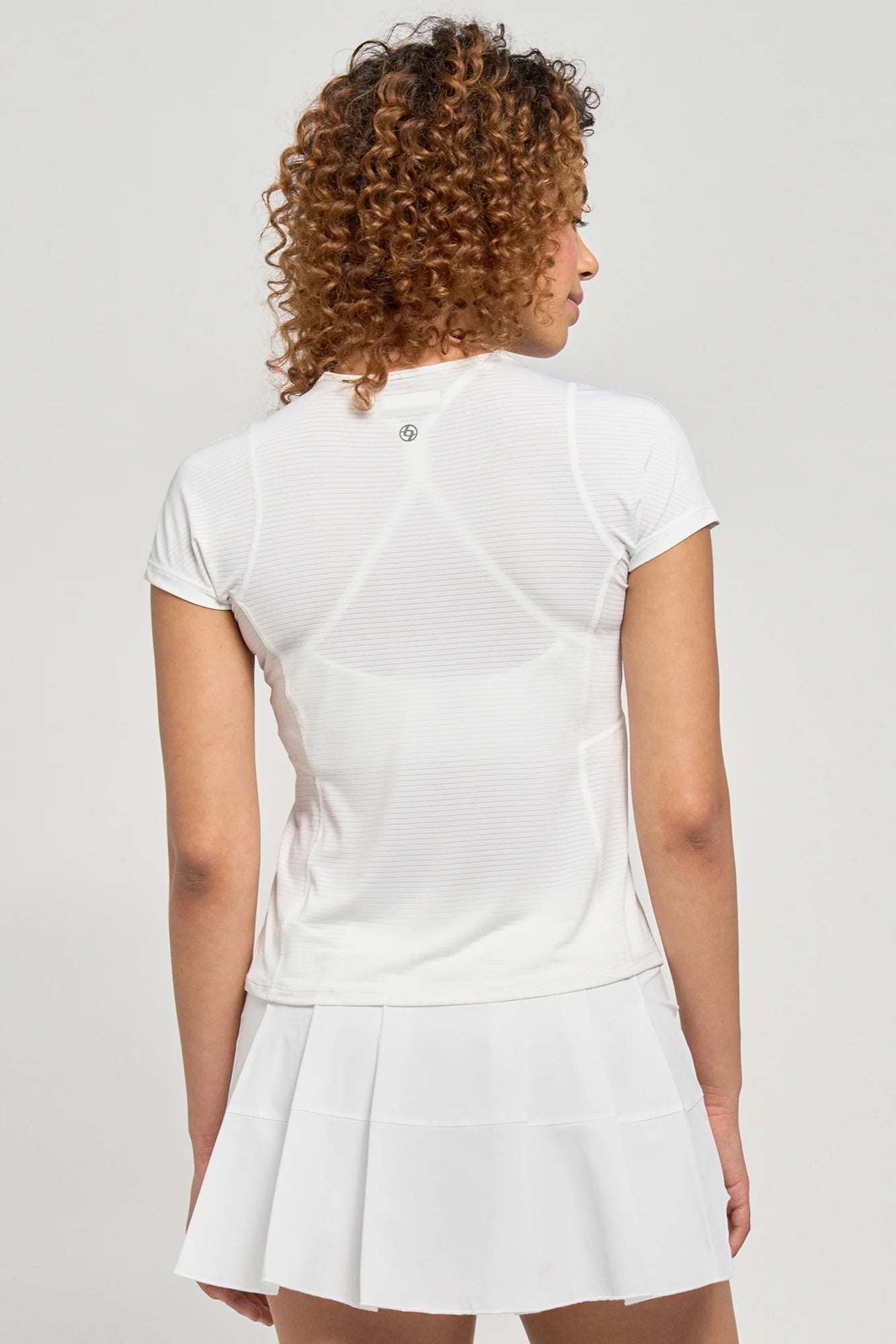 Lija Women's New Stripe Fluid Tennis Tee featuring lightweight performance fabric, moisture-wicking comfort, breathable construction, and modern striped styling.