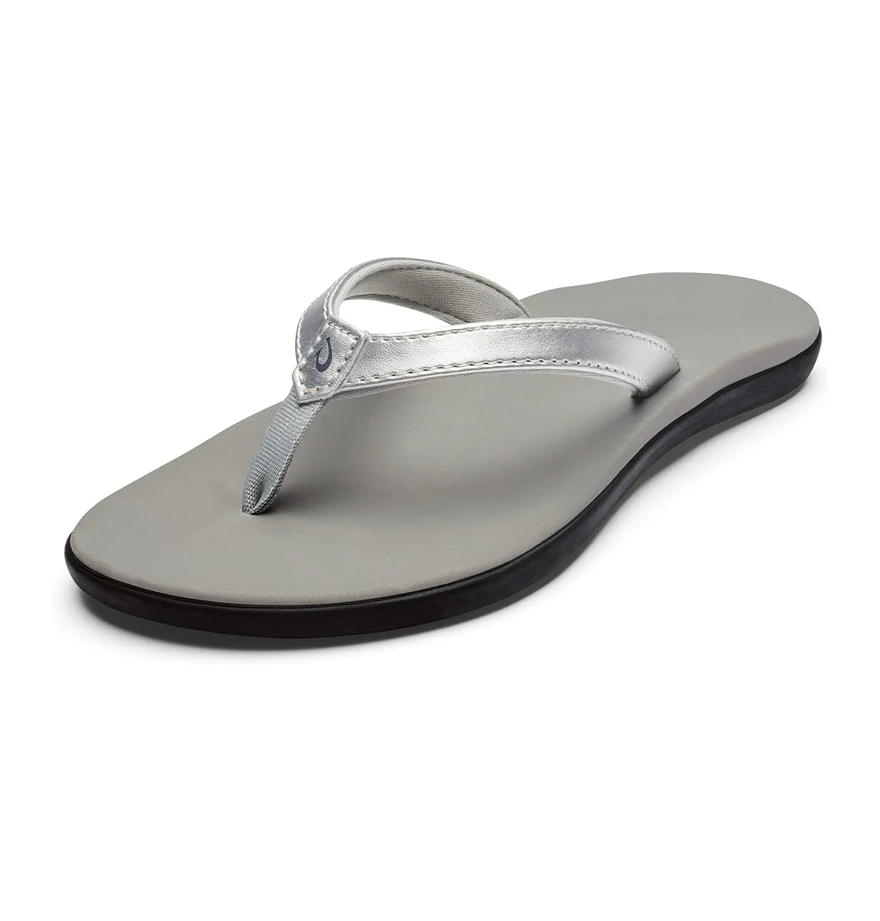 A silver Olukai Junior Girls Ho'opio flip-flop sandal with a grey sole on a white background
