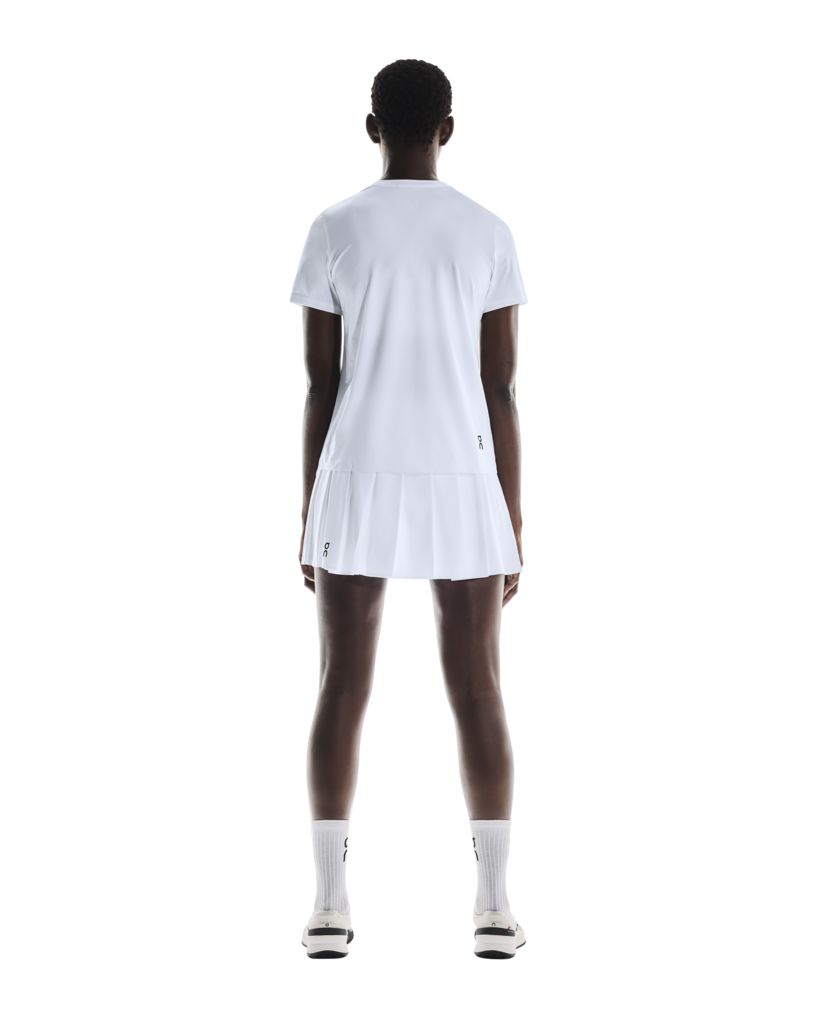 On Women's Court Pleated Skirt featuring lightweight performance fabric, pleated styling, built-in shorts, and athletic comfort.