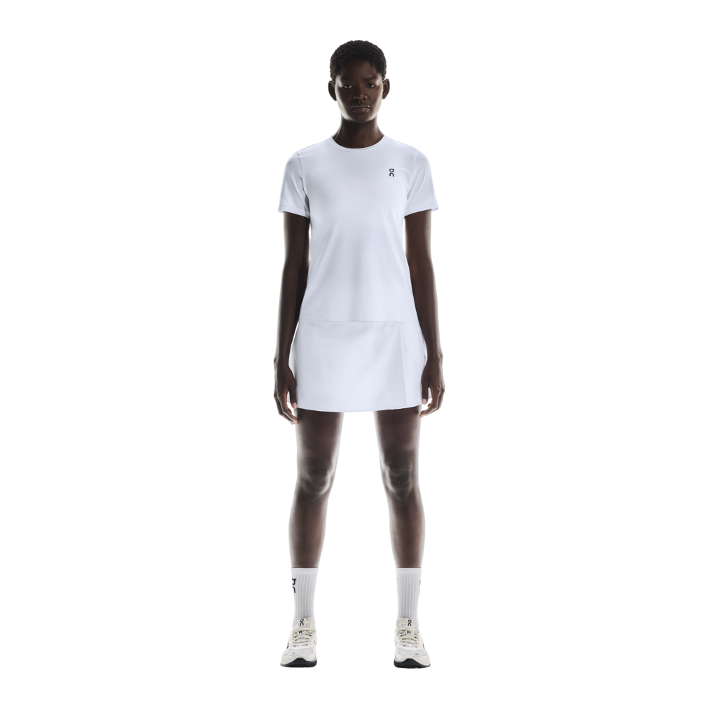 On Women's Court Pleated Skirt featuring lightweight performance fabric, pleated styling, built-in shorts, and athletic comfort.