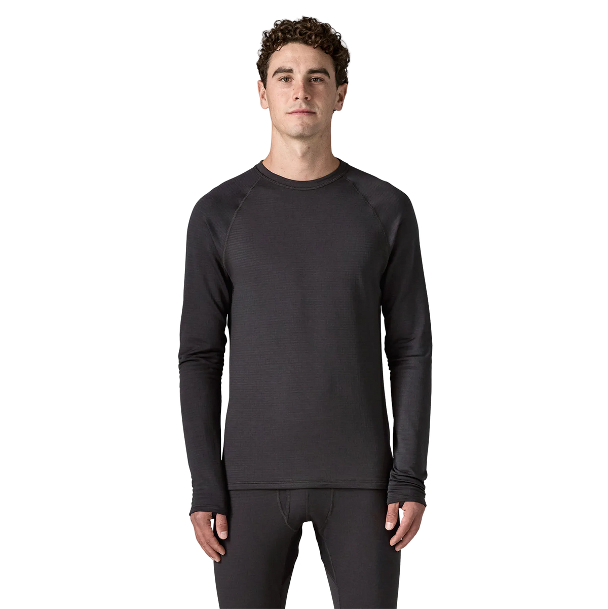 Front view of the black Patagonia Men's Capilene Thermal Weight Crew Baselayer featuring Polartec Power Grid fabric with an open-grid brushed interior, a self-fabric crewneck, offset shoulder seams, full underarm gussets, flatlock seam construction, elastic thumb loops, and a subtle drop-tail hem.