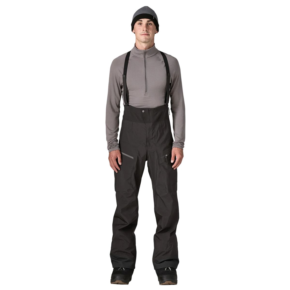 Front view of the Patagonia Men's PowSlayer Bib Pants featuring a 3-layer GORE-TEX Pro shell construction with a 100% recycled nylon face fabric, a low-profile bib with adjustable elastic suspenders, a full-coverage drop-seat configuration, watertight Vislon side ventilation zippers, dual thigh cargo pockets, a central chest pocket, inner ankle scuff guards, internal boot gaiters with gripper elastic, and a built-in RECCO reflector.