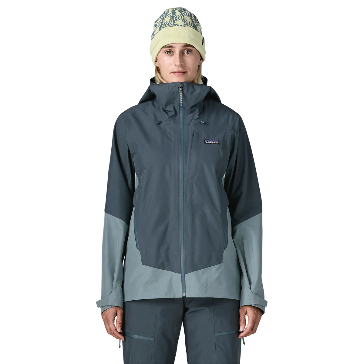 Front view of the Patagonia Women's Storm Shift Jacket featuring a 2-layer GORE-TEX fabric with 100% recycled polyester shell, a body-mapped zig-zag fleece lining, an adjustable two-way helmet-compatible hood with visor, a watertight center-front zipper, underarm pit zips for ventilation, dual zippered handwarmer pockets, a zippered chest pocket, an integrated powder skirt, and a built-in RECCO reflector.
