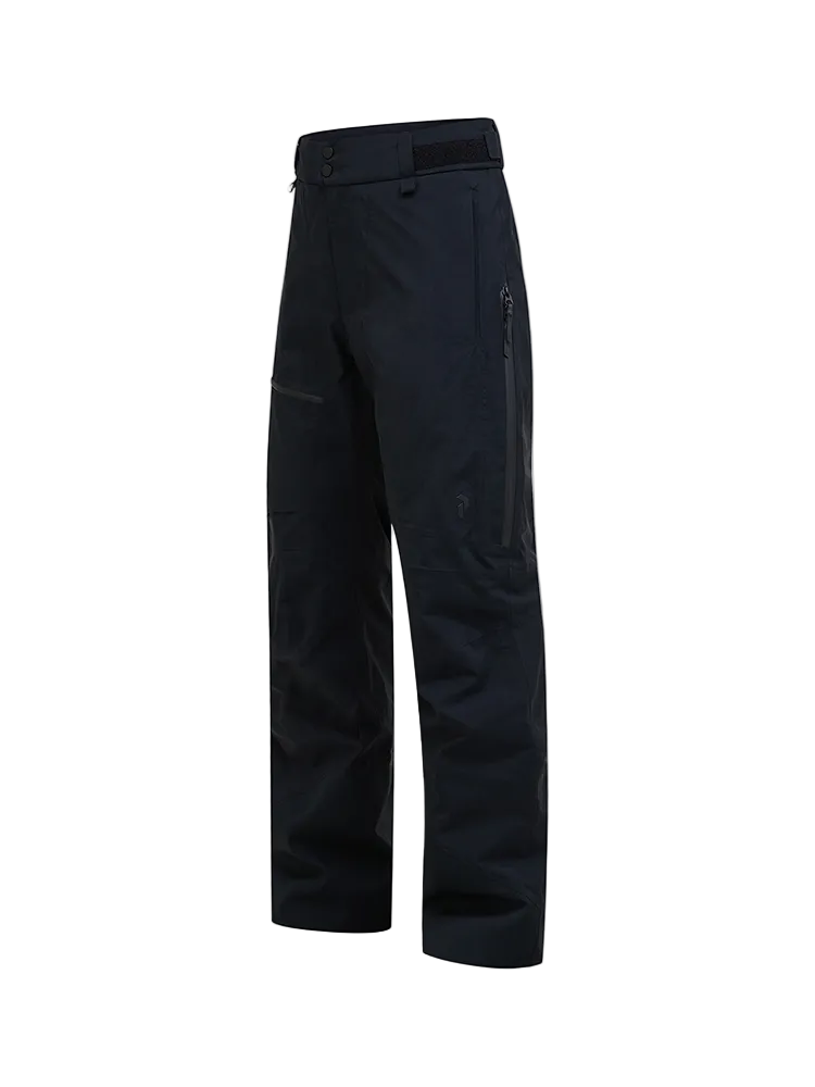 Side view of black Peak Performance Men's Alpine GORE-TEX 2L Insulated Shell Pants featuring a 2-layer GORE-TEX waterproof membrane, YKK AquaGuard zippered thigh vents, an adjustable waistband, and reinforced Cordura scuff guards.