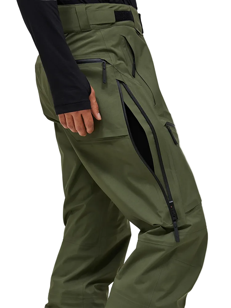 Side view of the pine needle green Peak Performance Men's GORE-TEX C-Knit 3L Shell Pants featuring 3-layer GORE-TEX fabric with C-KNIT backer technology, YKK AquaGuard leg ventilation zips, an adjustable velcro waistband, and reinforced Cordura lower leg scuff guards.