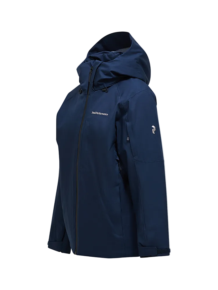 Side view of a blue shadow Peak Performance Men's Maroon HIPE 2L Insulated Shell Jacket featuring 2-layer HIPE stretch fabric, YKK AquaGuard zippers, a detachable helmet-compatible hood, and zippered underarm vents.