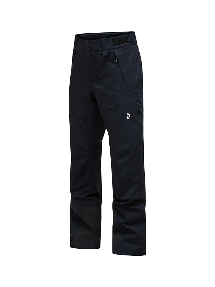 Side view of black Peak Performance Women's Anima HIPE 2L Insulated Shell Pants featuring 2-layer HIPE 2-way stretch fabric, YKK AquaGuard zippered thigh vents, an adjustable velcro waistband, and reinforced lower leg scuff guards.