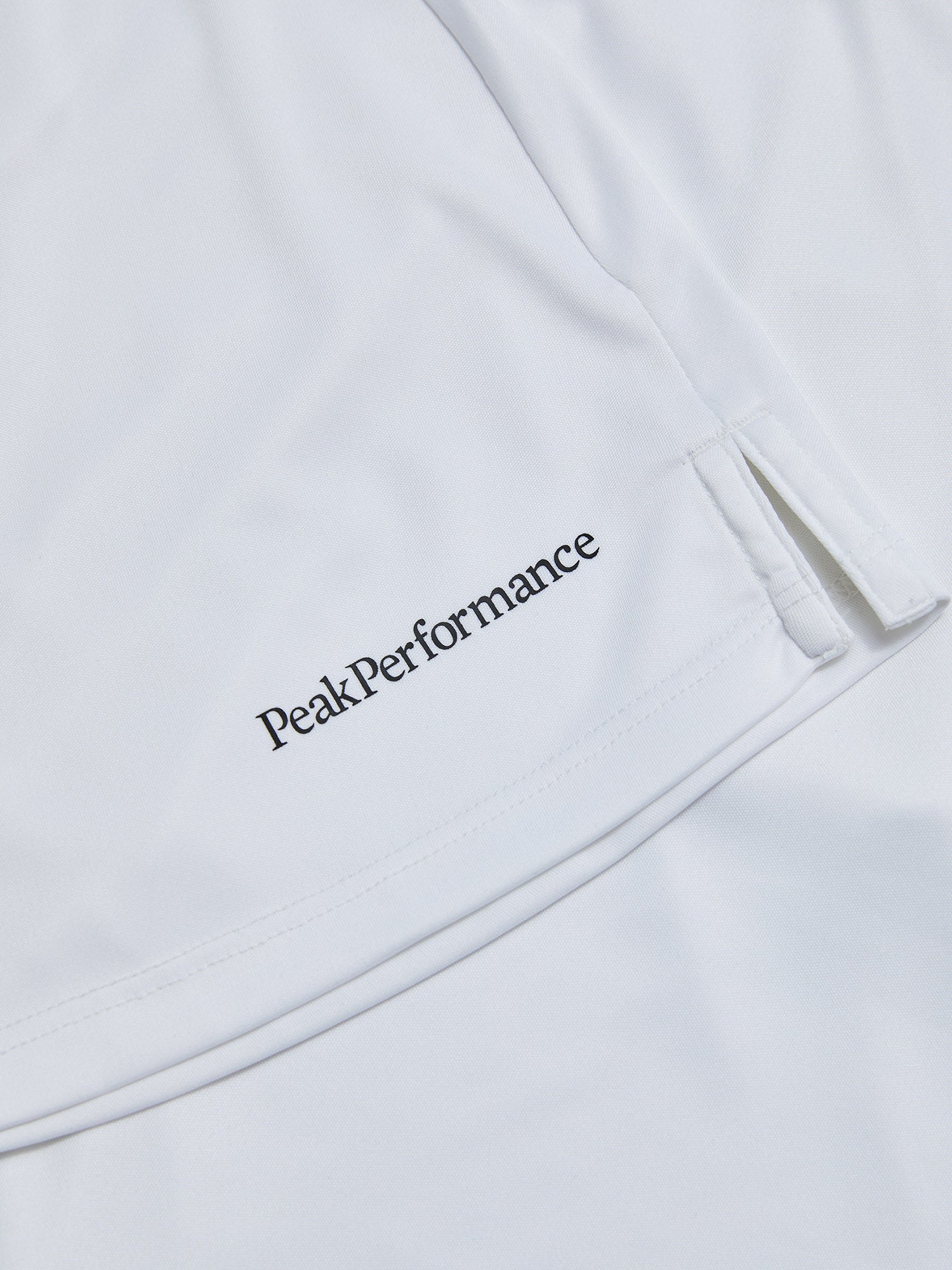 Peak Performance Women's Player Golf Skirt featuring lightweight stretch fabric, built-in shorts, and a flattering athletic fit.