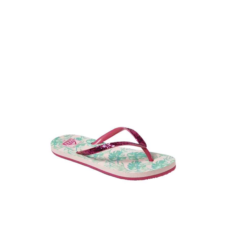 Pair of Reef Junior Stargazer Paradise flip-flops with pink straps and tropical leaf pattern on a white background