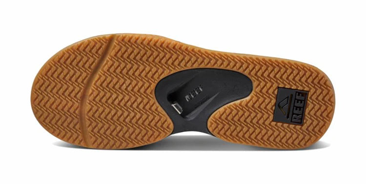 A black Reef Men's Fanning sandal on a white background
