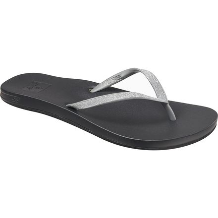 A Reef Women's Cushion Bounce Stargazer flip-flop sandal in black and silver
