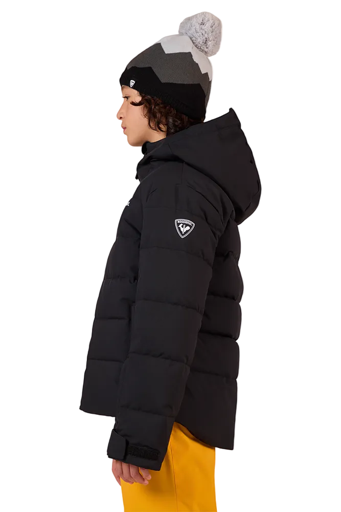 Side view of a black Rossignol Jr Boys’ Siz Quilted Jacket featuring high-loft synthetic insulation, quilted baffle construction, DWR-treated shell, high stand-up collar, and zippered handwarmer pockets.