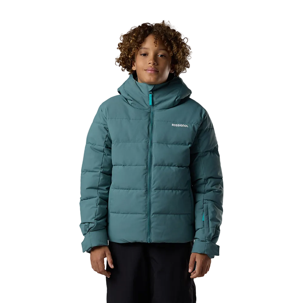 Front view of a blue Rossignol Jr Boys’ Siz Quilted Jacket featuring high-loft synthetic insulation, quilted baffle construction, DWR-treated shell, high stand-up collar, and zippered handwarmer pockets.