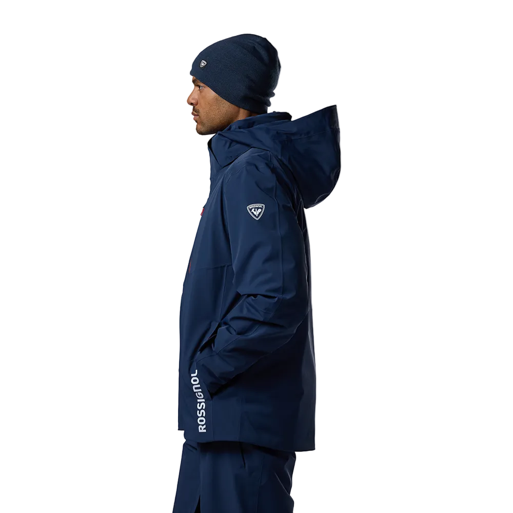 Side view of a dark navy Rossignol Men’s 4WS Blackside Insulated Jacket featuring four-way stretch waterproof membrane fabric, synthetic insulation, helmet-compatible hood, and underarm pit vents.