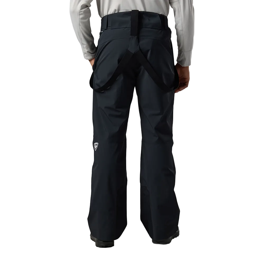 Rear view of black Rossignol Men’s 4WS Blackside Insulated Pants featuring four-way stretch waterproof membrane fabric, synthetic insulation, adjustable waist tabs, zippered leg vents, integrated boot gaiters, and reinforced hem scuff guards.