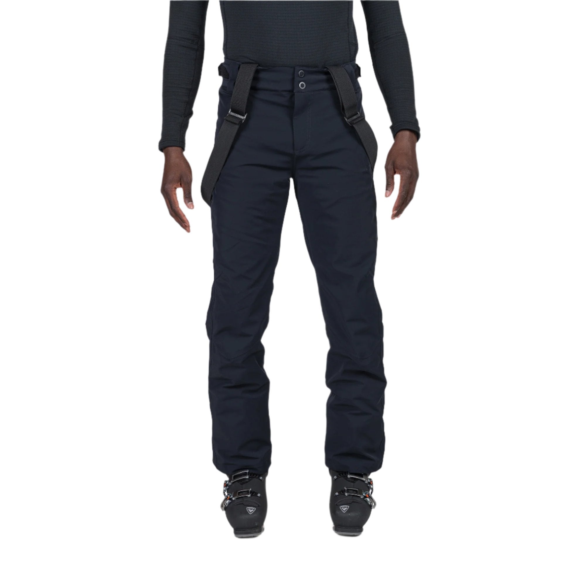A man wearing a pair of black Rossignol Men's Blackside Ski Pants that are waterproof, breathable, stretchable, and insulated.