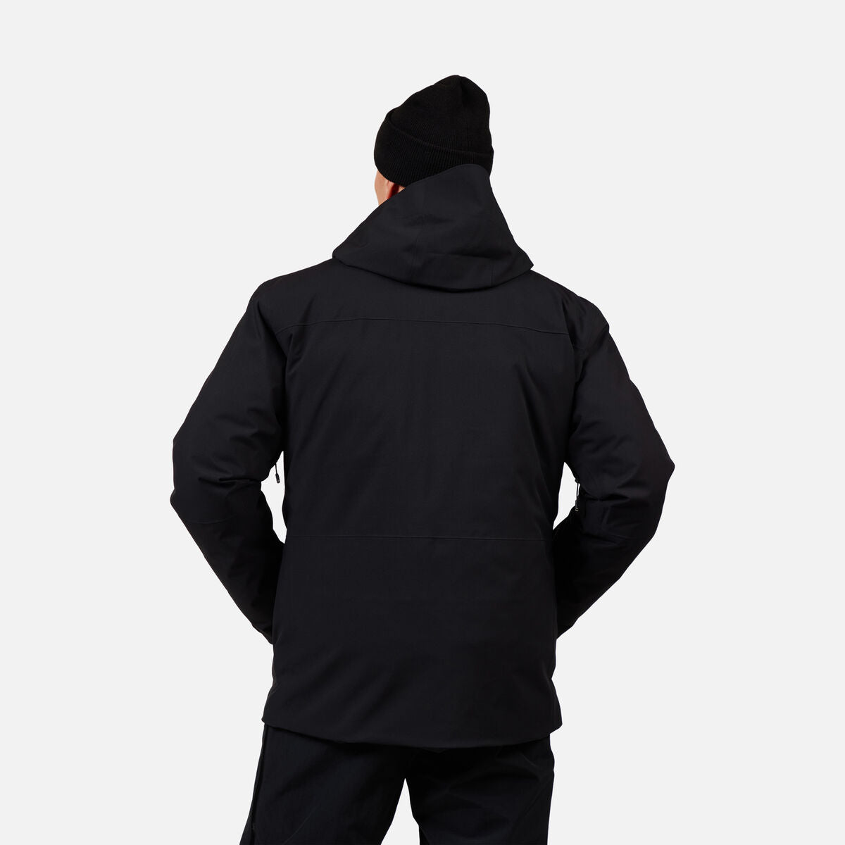 A man wearing a black Rossignol Men's Desafio 2L Shell Ski Jacket that is waterproof, stretchable, and breathable.