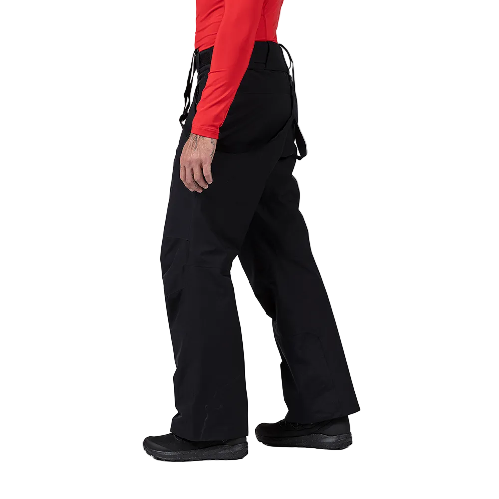 Side view of black Rossignol Men’s Insulated Ski Pants featuring waterproof membrane fabric, synthetic insulation, adjustable waist tabs, integrated boot gaiters, and reinforced hem scuff guards.