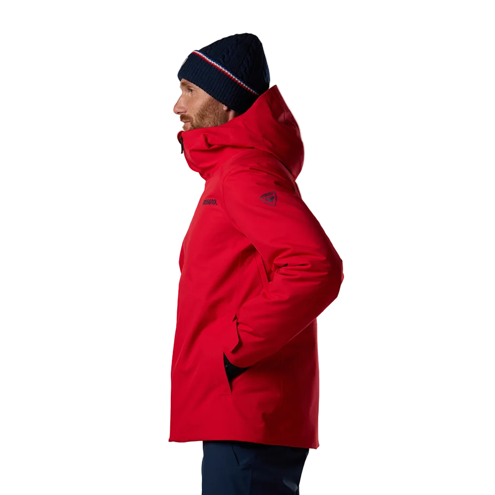 Side view of a red Rossignol Men’s Rochrun Insulated Jacket featuring waterproof membrane fabric, synthetic insulation, helmet-compatible hood, and zippered underarm pit vents.