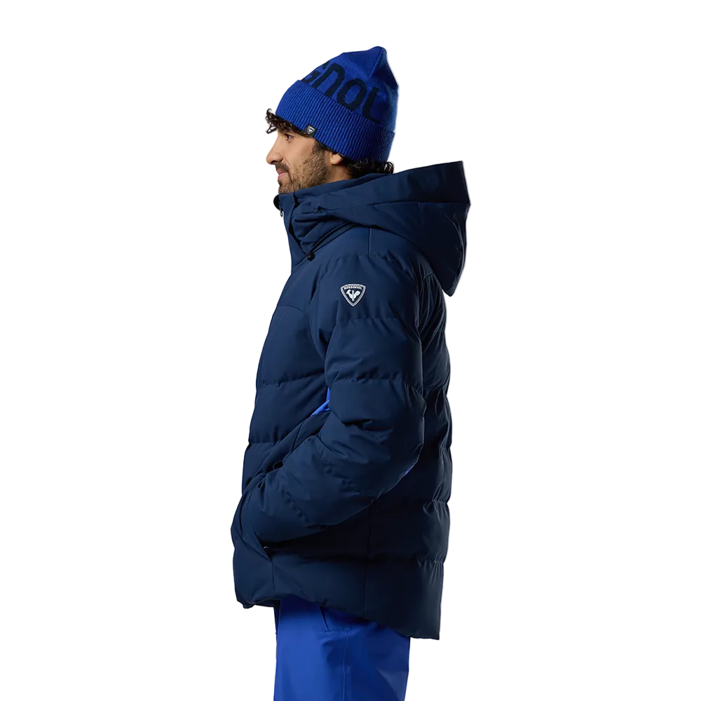 Side view of a navy blue Rossignol Men’s Sizle Insulated Jacket featuring waterproof membrane fabric, synthetic insulation, adjustable hood, and underarm pit vents.