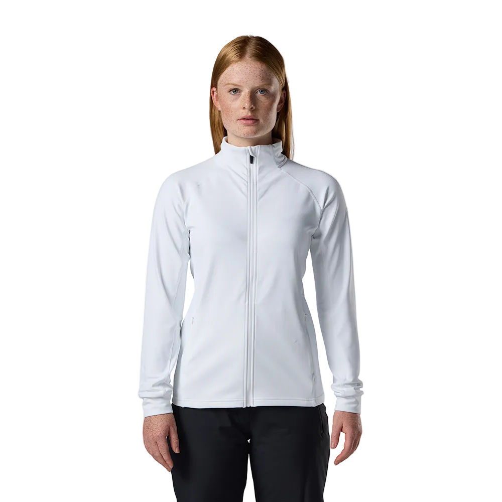 Front view of a white Rossignol Women’s Midlayer Stretch Jacket featuring multi-directional stretch fabric, a thermal fleece interior, full-length front zipper, and zippered hand pockets.