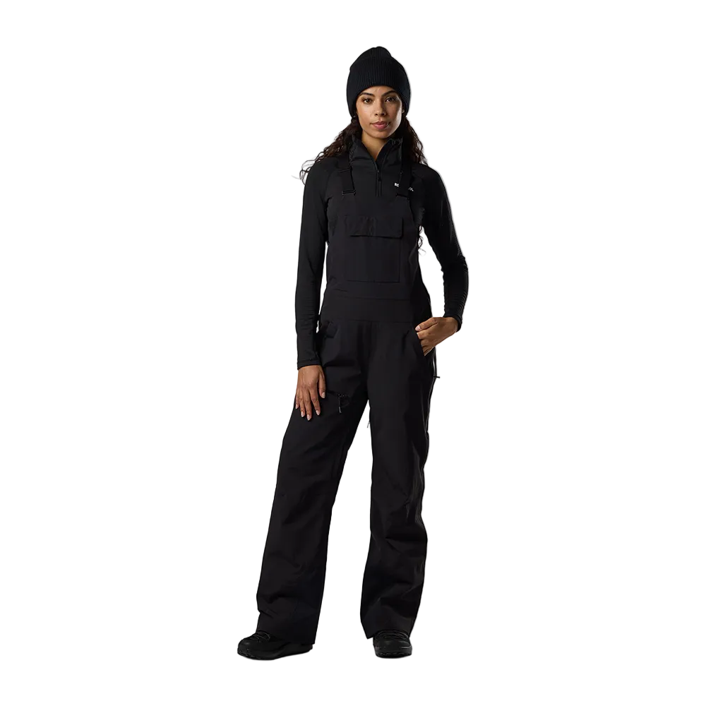 Front view of black Rossignol Women’s Outerlimits Insulated Bib Pants featuring high-chest bib construction, waterproof membrane fabric, adjustable suspenders, zippered inner thigh vents, integrated boot gaiters, and reinforced hem scuff guards.