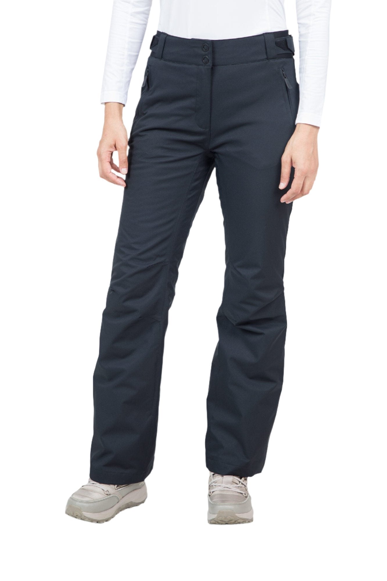 A woman wearing a pair of black Rossignol Women's Ski Pants that are waterproof, breathable, stretchable, and insulated.