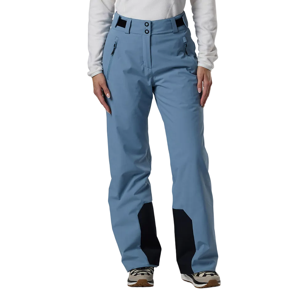 Front view of the blue aura Rossignol Women’s Strawpile Insulated Pants featuring waterproof membrane fabric, recycled synthetic insulation, adjustable waist tabs, integrated boot gaiters, and reinforced hem scuff guards.