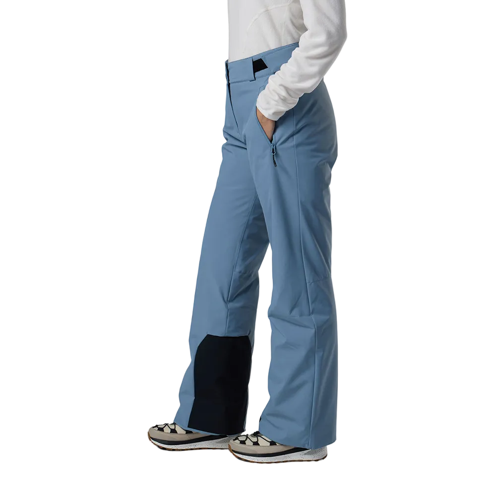 Side view of the blue aura Rossignol Women’s Strawpile Insulated Pants featuring waterproof membrane fabric, recycled synthetic insulation, adjustable waist tabs, integrated boot gaiters, and reinforced hem scuff guards.