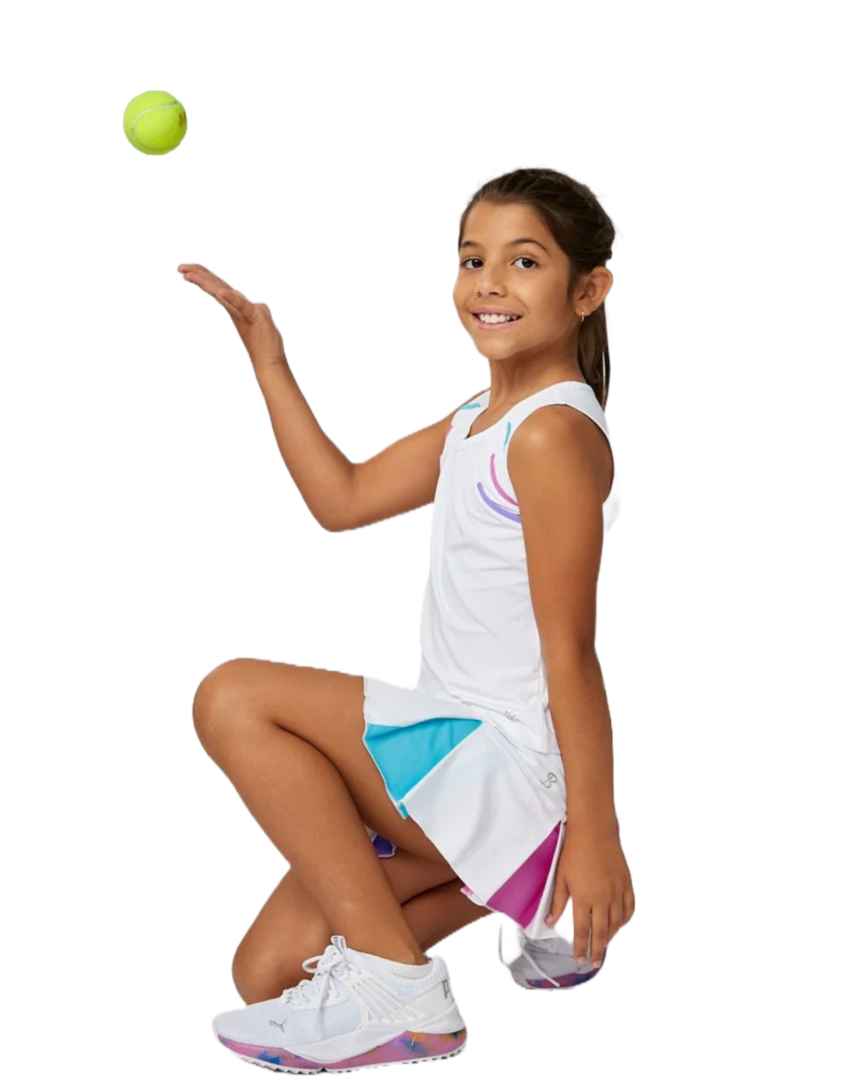 A girl wearing a white Sofibella Girls Spectrum Tank Top and skirt tossing a tennis ball on a white background.