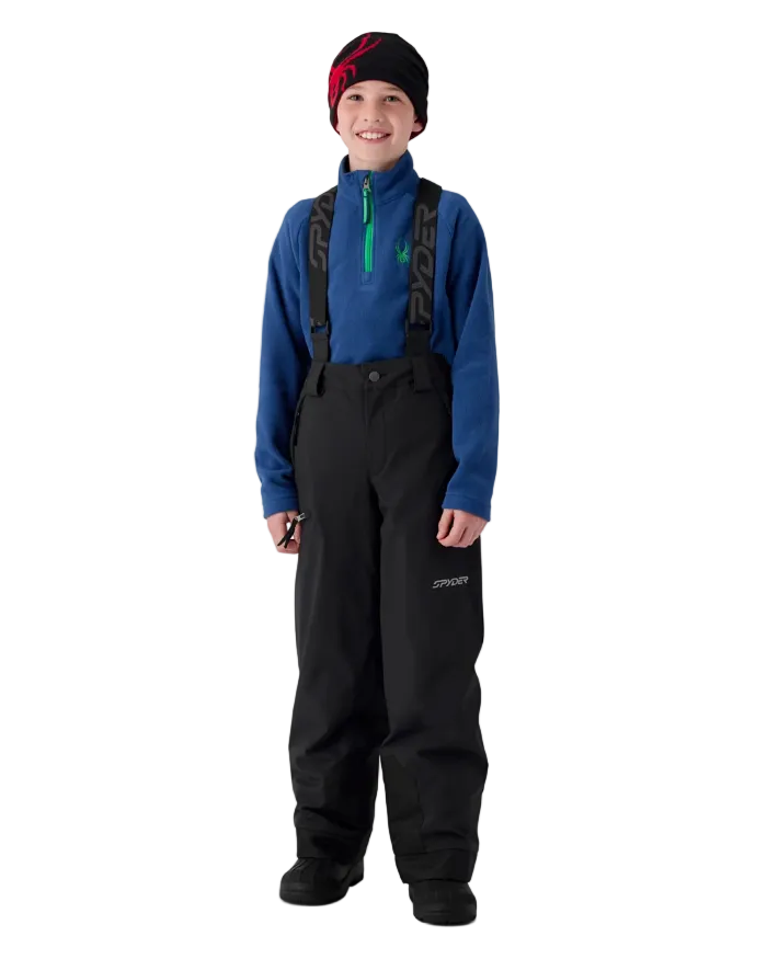 A boy wearing a Spyder Boys’ Propulsion Pants featuring EXO SHIELD 10K stretch recycled polyester shell, 60g ThermaWEB insulation, critically taped seams, removable adjustable suspenders, and inner snow gaiters.